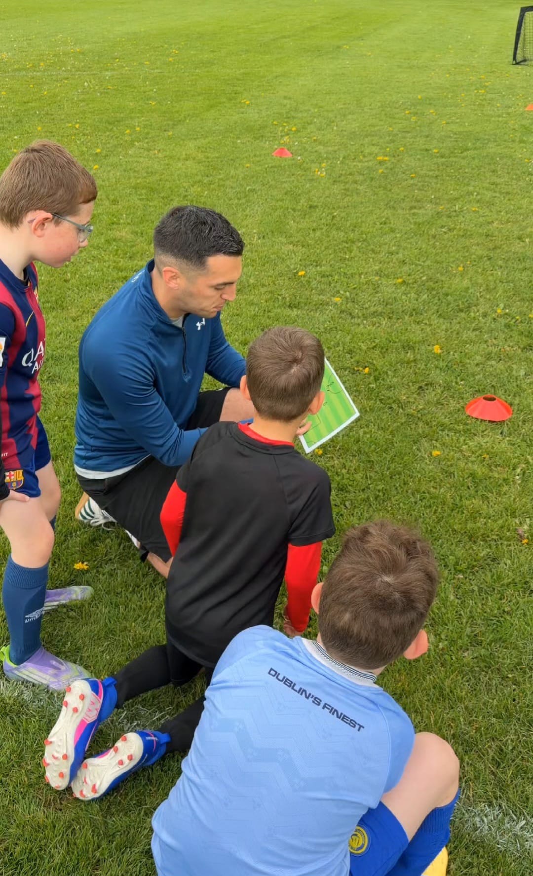 Coach and young players planning a game strategy